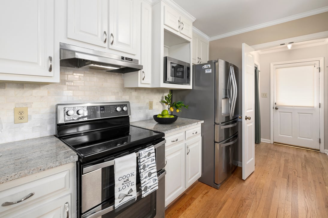 A White Themed Kitchen with Stainless Steel Appliances